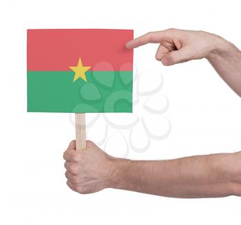 Hand holding small card, isolated on white - Flag of Burkina Faso