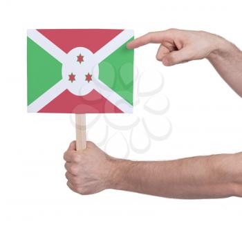 Hand holding small card, isolated on white - Flag of Burundi