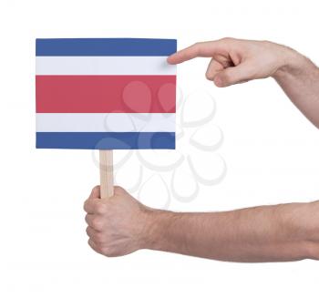 Hand holding small card, isolated on white - Flag of Costa Rica
