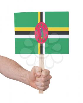 Hand holding small card, isolated white - Flag of Dominica