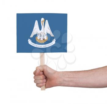 Hand holding small card, isolated on white - Flag of Louisiana