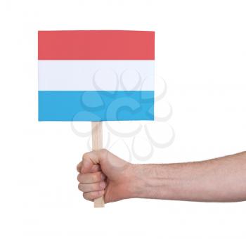 Hand holding small card, isolated on white - Flag of Luxembourg