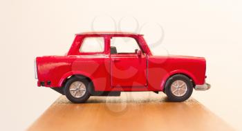 Old red toy car, isolated, selective focus