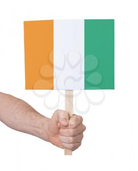 Hand holding small card, isolated on white - Flag of Ivory Coast