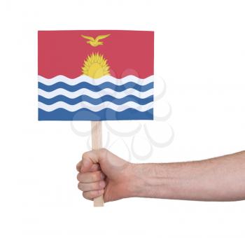Hand holding small card, isolated on white - Flag of Kiribati