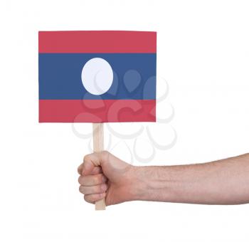 Hand holding small card, isolated on white - Flag of Laos