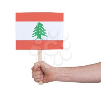 Hand holding small card, isolated on white - Flag of Lebanon