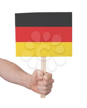 Hand holding small card, isolated on white - Flag of Germany