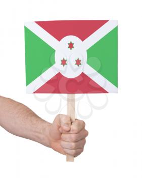 Hand holding small card, isolated on white - Flag of Burundi