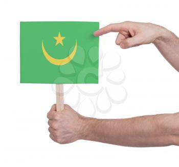 Hand holding small card, isolated on white - Flag of Mauritania