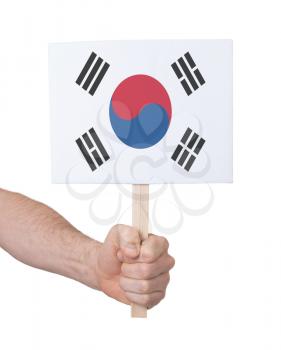 Hand holding small card, isolated on white - Flag of South Korea