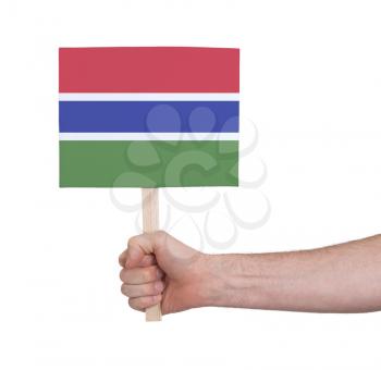 Hand holding small card, isolated on white - Flag of Gambia