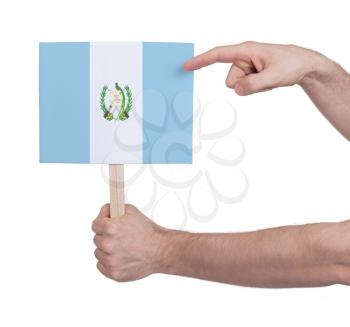 Hand holding small card, isolated on white - Flag of Guatemala