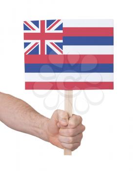 Hand holding small card, isolated on white - Flag of Hawaii