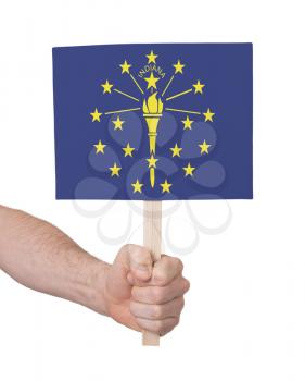 Hand holding small card, isolated on white - Flag of Indiana