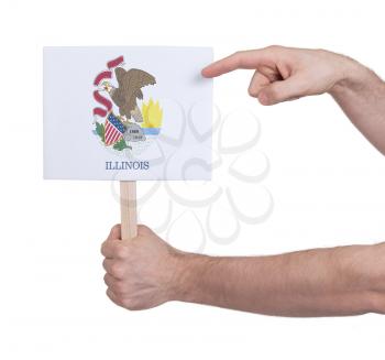 Hand holding small card, isolated on white - Flag of Illinois