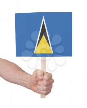Hand holding small card, isolated on white - Flag of Saint Lucia
