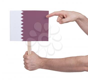 Hand holding small card, isolated on white - Flag of Qatar