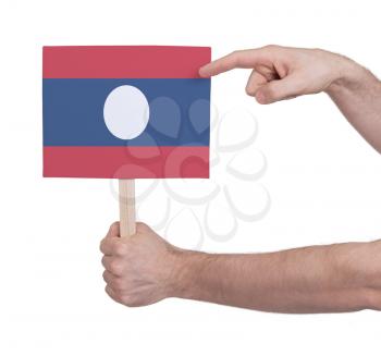 Hand holding small card, isolated on white - Flag of Laos