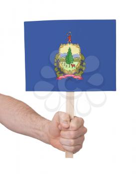 Hand holding small card, isolated on white - Flag of Vermont