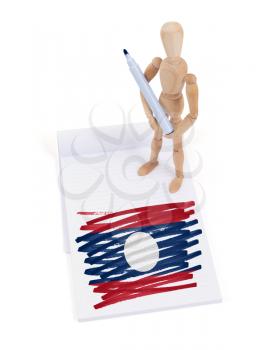 Wooden mannequin made a drawing of a flag - Laos