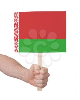Hand holding small card, isolated on white - Flag of Belarus