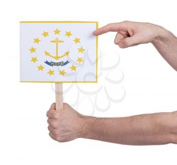Hand holding small card, isolated on white - Flag of Rhode Island