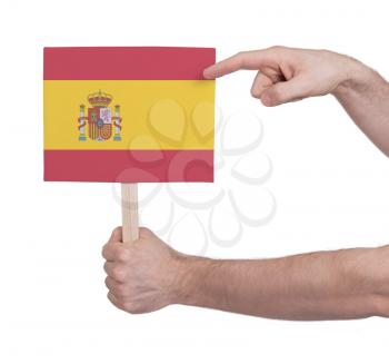 Hand holding small card, isolated on white - Flag of Spain