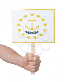 Hand holding small card, isolated on white - Flag of Rhode Island