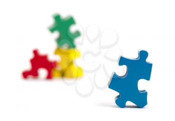 Closeup of big jigsaw puzzle piece isolated on white, perspective