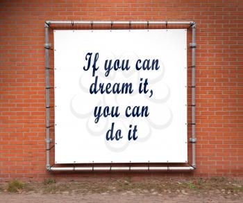 Large banner with inspirational quote on a brick wall - If you can dream it, you can do it