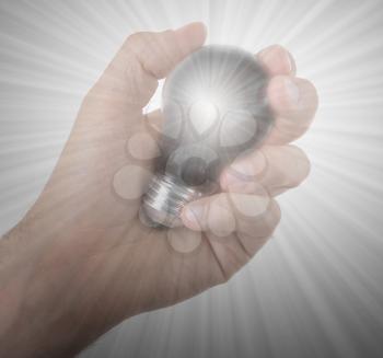 Hand holding an light bulb isolated on white background