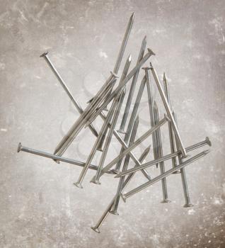 Many metal nails on a vintage background