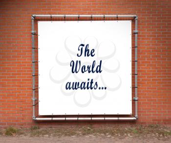 Large banner with inspirational quote on a brick wall - The world awaits