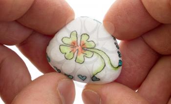 Stone with drawing of a clover four and small hearts, isolated