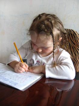 the little girl with nice hair-do learning her  home tasks