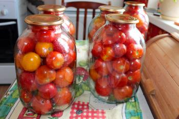 image of tomatos in jars prepared for preservation