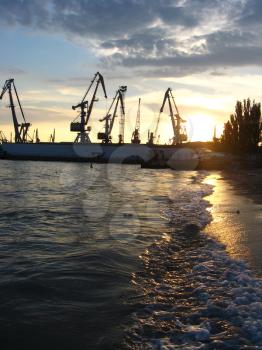 panorama of the everning sea with docks and hoisting crane