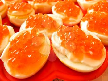 a lot of sandwiches with red caviar on the boiled egg