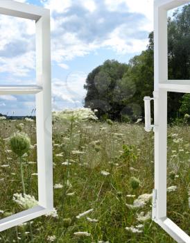 the image of opened window to the summer field