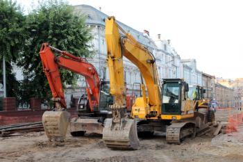 two modern and big excavators working on the Lvov's street
