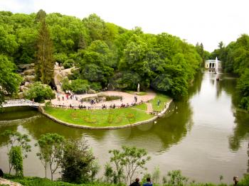 Beautiful city park with bushes, trees and lake