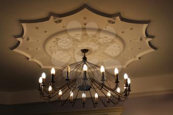 Beautiful chandelier under the top with romantic candles