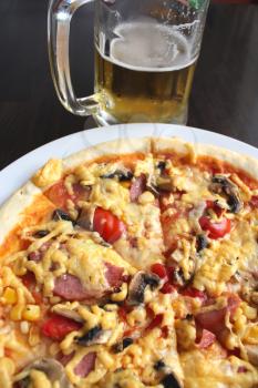 very tasty pizza with glass of fresh beer