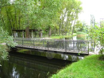 nice bridge across river in the park