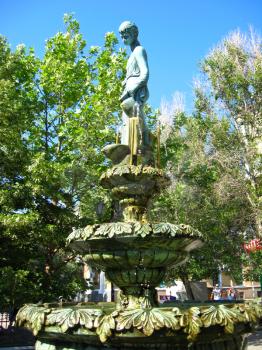 Statue of the boy with a fountain in city centre of Berdyansk