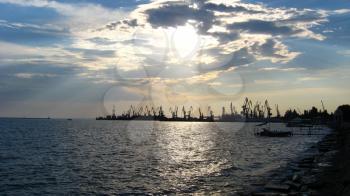 panorama of the everning sea with docks and hoisting crane