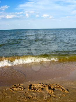 image of marine waves inscription on marine sand