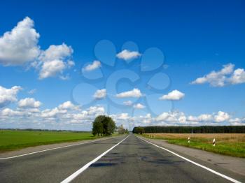 The image of asphalted road and the blue sky
