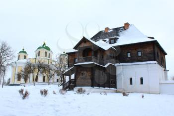 the wooden house and beautiful church in winter in Ukraine